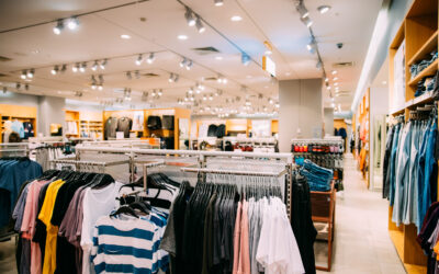 Colorful Bright Clothes On Shelves And Hanger In Store Of Shopping Center.